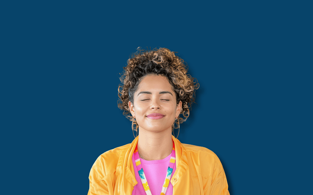 A person in a yellow jacket and pink shirt with a colorful lanyard against a blue background, explaining when to use the F99 diagnosis code. This code helps classify unspecified mental health disorders for accurate billing and treatment.