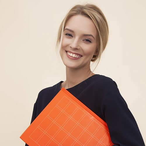 Receptionist at Medical Claims Billing, holding an orange folder and smiling